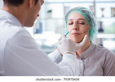 Plastic surgeon preparing for operation on woman face