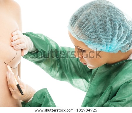 Plastic surgeon woman drawing on body lines for breast implant operation