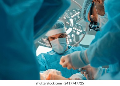 Plastic surgeons perform surgery on a patient - Powered by Shutterstock