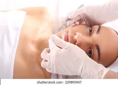 Plastic Surgery Wrinkle Reduction.Caucasian Woman During Surgery Using A Scalpel