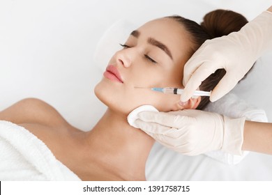 Plastic Surgery. Young Woman Receiving Botox Injection In Beauty Clinic