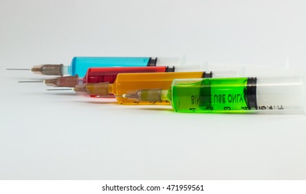 plastic syringes containing multicolor solutions