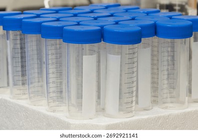 Plastic test tubes empty bottle vials milliliter measurement with caps in styrofoam tray.