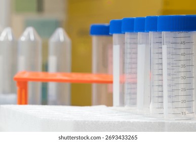 Plastic test tubes empty bottle vials milliliter measurement with caps in styrofoam tray.