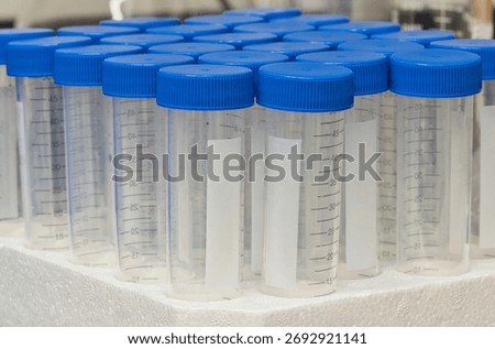 Plastic test tubes empty bottle vials milliliter measurement with caps in styrofoam tray.