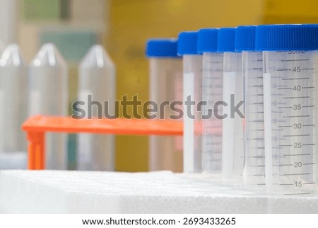 Plastic test tubes empty bottle vials milliliter measurement with caps in styrofoam tray.
