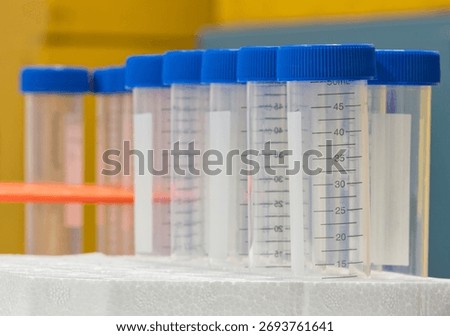Plastic test tubes empty bottle vials milliliter measurement with caps in styrofoam tray.