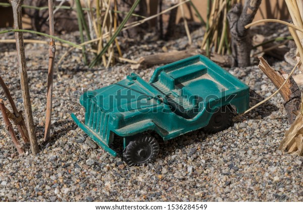 plastic toy car, plastic toy car in combat\
field, plastic toy, small toy combat\
car