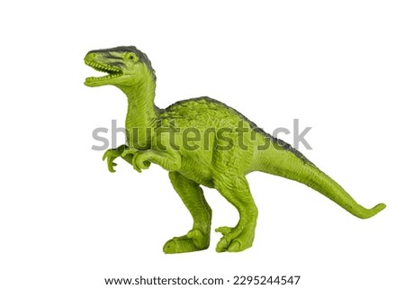A plastic toy dinosaur isolated on a white background with copy space