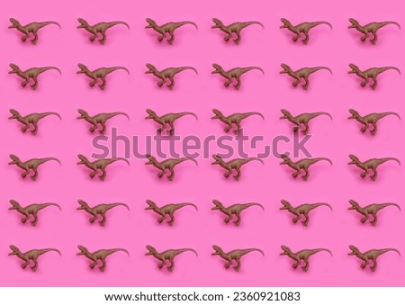 plastic toy dinosaurs on pink background pattern 