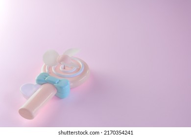 Plastic Toy Fan On Pink Color Background.