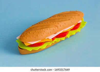 Plastic Toy Fat Food  Sandwich On Blue Background