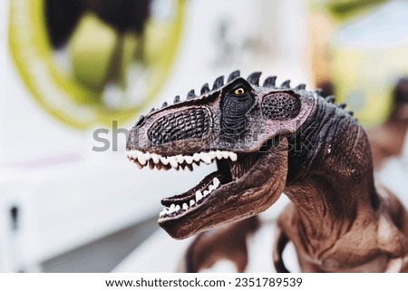 Plastic toy figurine of a dinosaur with an open mouth