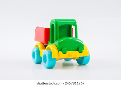 Plastic toy multi-colored truck on a white background. - Powered by Shutterstock