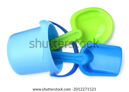 Plastic toy shovels and bucket on white background, top view