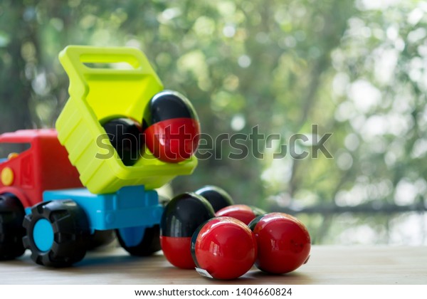 Plastic toy truck carry egg\
toys open inside mini toy to surprise. Concept of delivering toy\
for fun