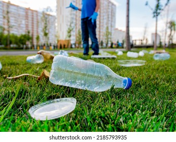 plastic trash on the green lawn in the park. Environmental pollution