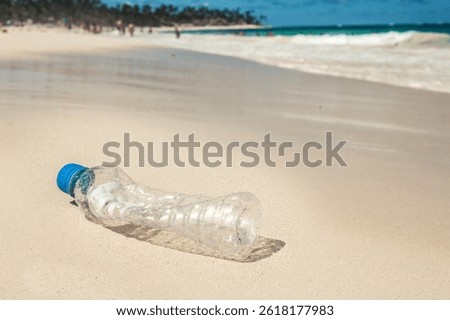 Plastic trash at the sandy beach. Plastic pollution concept. Single-use plastic is a human addiction that is destroying our planet and impacts our waters, sea life and humans