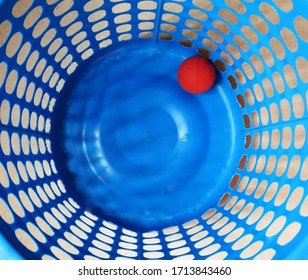 Plastic Washing Basket With Bright Red Ball Inside Viewed From Above