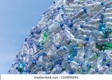 
A lot of plastic waste bottles with a beautiful blue sky in the background