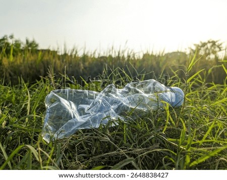 Plastic waste in the fields. Plastic pollution in rice farming. Plastic bottle waste in rice farming fields. polluted enviroment. Agricultural environment plastic pollution. 