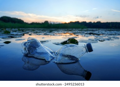 Plastic waste in lake. Ocean pollution, marine debris. Marine litter. Garbage plastic bottle in water of pond. Plastic marine debris. Marine plastic pollution. Microplastics groundwater poisoning.