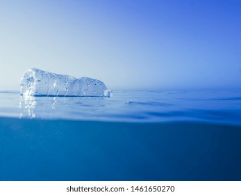 Plastic Waste At The Ocean, A Plastic Bottle Floating In The Mediterranean Sea At The Water Surface, Environmental Problem With Plastics Pollution, Copy Space For Text