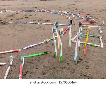 Plastic Waste Ocean. Toothbrush Pollution On The Beach. Enviromental Waste Problem On Planet.