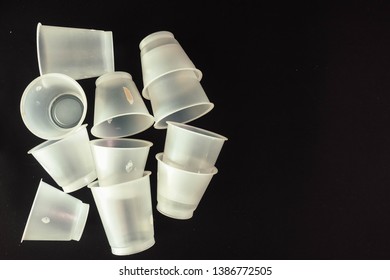 Plastic Waste - White Plastic Yogurt Cups With Recycling Code PS 06 Polystyrene, Isolated, Black Background