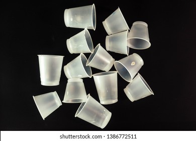 Plastic Waste - White Plastic Yogurt Cups With Recycling Code PS 06 Polystyrene, Isolated, Black Background