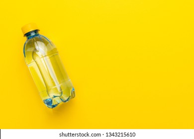 plastic water bottle with yellow cap on the yellow background with copy space - Shutterstock ID 1343215610
