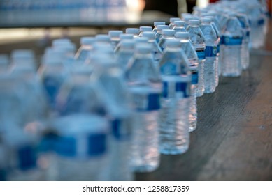 Plastic Water Bottles Lined Up In Large Quantity For Single Use. 