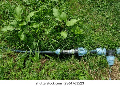 Plastic water pipes on the green grass. Installation of water supply. - Shutterstock ID 2364761523