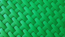 Plastic Weave Pattern Background. Zigzag Interlocking Of Symmetrical Shapes. Green Woven Background.