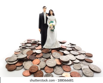 Plastic wedding couple on a pile of coins - money concept                                - Powered by Shutterstock