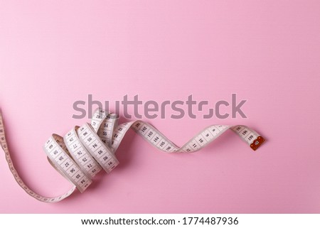 plastic white metric ruler for measuring on pink background. minimalism. space for text