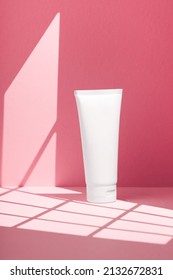 Plastic White Tube For Cream Or Lotion. Skincare Or Sunscreen Cosmetic In Top View On Pink Background With Shadow. Beauty Concept For Face Care