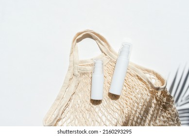 Plastic White Tubes For Cream Or Lotion And Cloth Shopping Bag. Sunscreen Cosmetic On White Background With Shadows From Palm Leaves. Beauty Summer Concept For Face Care