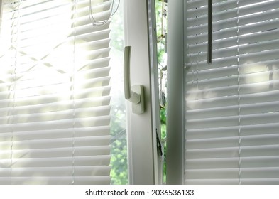 A plastic window with blinds is open for ventilation mode.