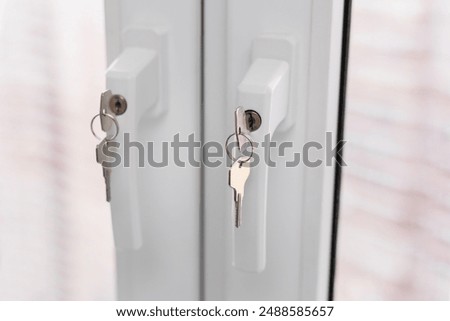 Plastic window closes with a key inserted into the keyhole. Protection for children