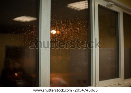 Plastic windows in the evening. Wet glass in the interior. Office sashes of window frames.