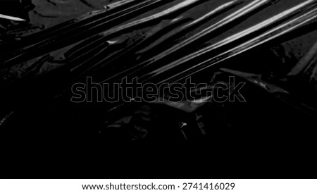 Plastic wrap texture overlay effect on black background. Shrink wrapped plastic sleeve for cover. White plastic