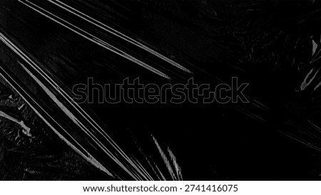Plastic wrap texture overlay effect on black background. Shrink wrapped plastic sleeve for cover. White plastic