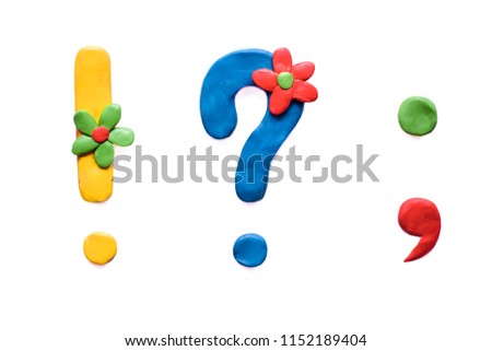 Plasticine colored punctuation marks: exclamation mark, question mark, dot, comma with flowers, isolate on white background