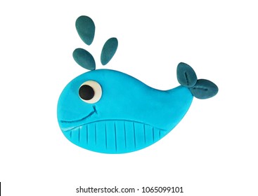 Plasticine cute blue whale spraying water isolated on a white background. Clipping path.