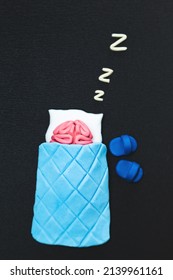 Plasticine Pink Human Brain Is Sleeping. Mind Rest Concept. Dark Background.