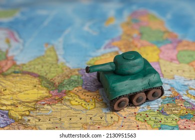 A Plasticine Tank On The Background Of A World Map, As A Symbol Of Peace And Goodness. There Is No War Appeal. Stop War.