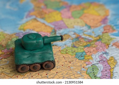 A Plasticine Tank On The Background Of A World Map, As A Symbol Of Peace And Goodness. There Is No War Appeal. Stop War.