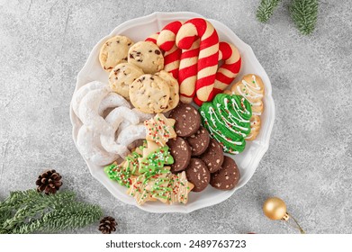 A plate with assorted homemade Christmas cookies on a gray concrete background. Festive food. Top view, copy space - Powered by Shutterstock