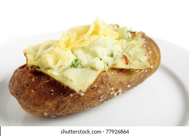 A Plate With A Baked Idaho Russet Potato Split Open And Creamed With Butter And Fresh Parsley, Topped With Mixed Cheddar And Mozzarella Cheeses